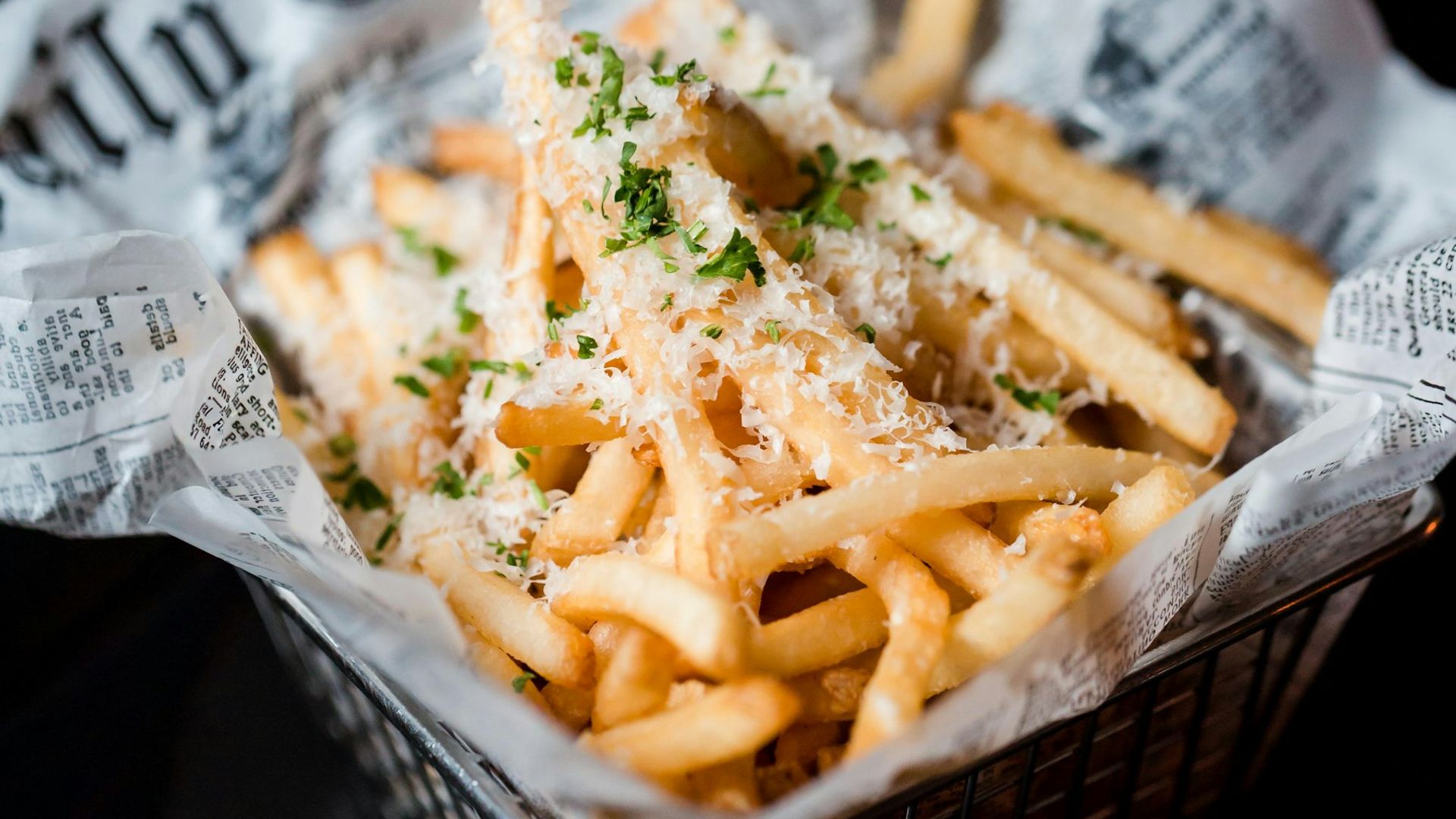 Loaded fried potatoes with melted cheese and herbs